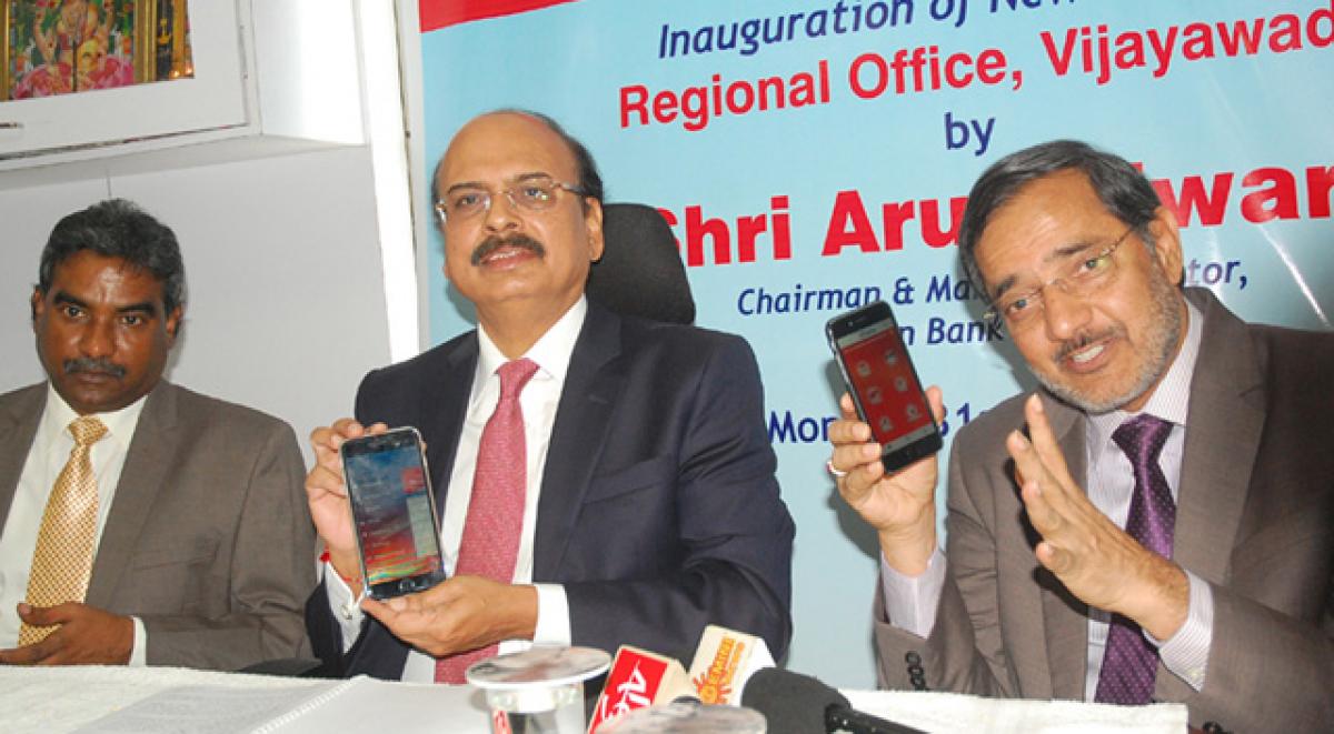 From left: DGM Dr K L Raju, Union Bank of India, Chairman Arun Tiwari and Field General Manager K Chandrashekar. Arun Tiwari explaining the mobile banking procedure during the inauguration of the bank&rsquo;s regional office at Madhu Malaxmi Chambers in Vijayawada on Monday. Photo: N Kishore